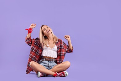 Photo of Happy hippie woman on purple background. Space for text