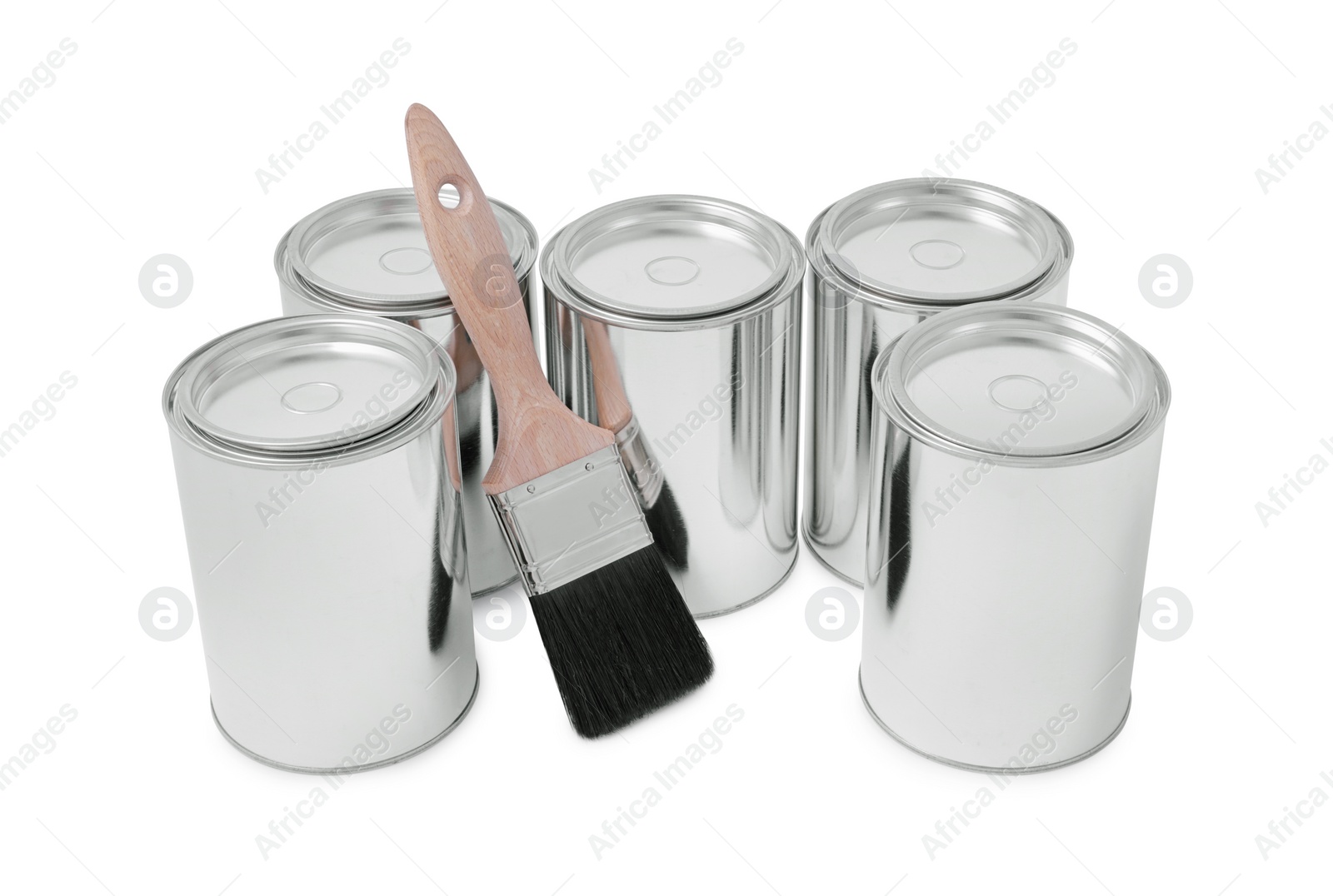 Photo of Cans of paints and brush on white background