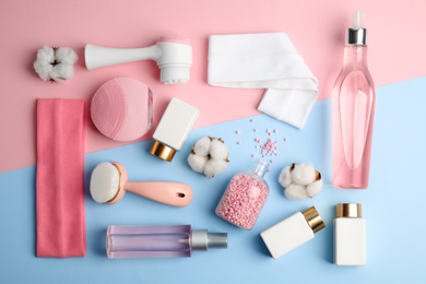 Photo of Flat lay composition with face cleansing brushes on color background. Cosmetic tools