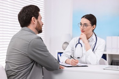 Doctor consulting patient during appointment in clinic