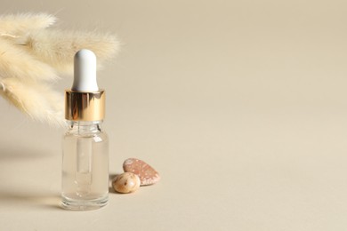 Photo of Composition with bottle of cosmetic serum on beige background. Space for text