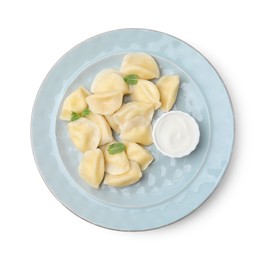 Photo of Plate of delicious dumplings (varenyky) with cottage cheese,mint and sour cream isolated on white, top view