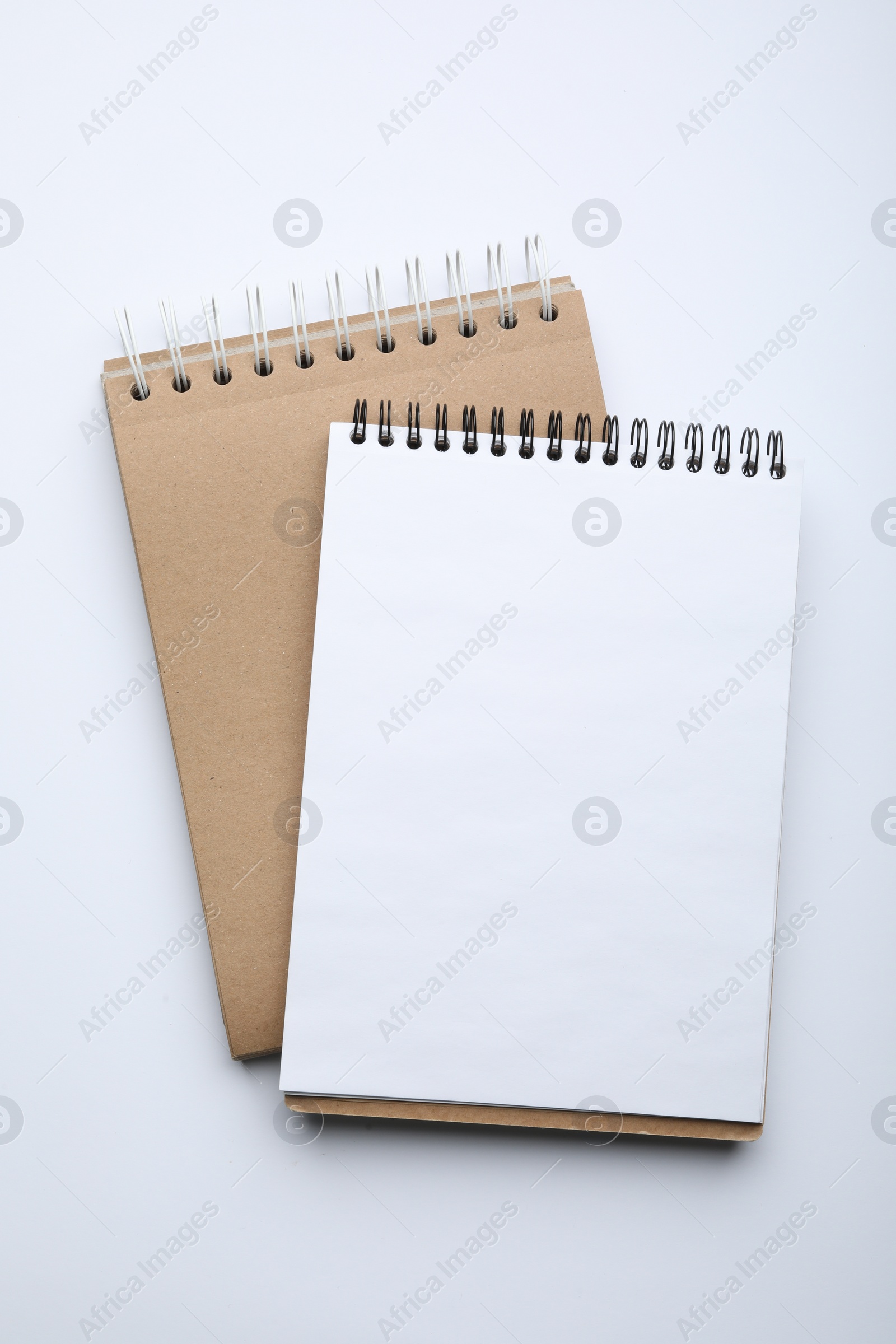 Photo of Stylish notebooks isolated on white, top view