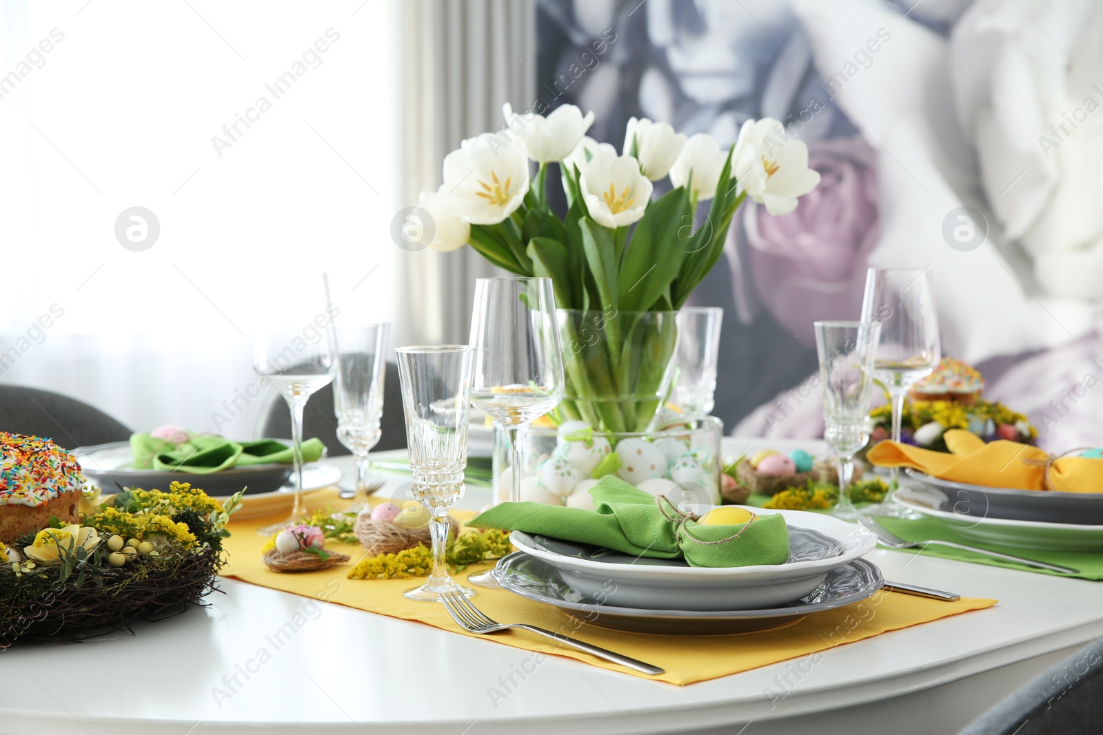 Photo of Festive Easter table setting with beautiful white tulips and eggs indoors