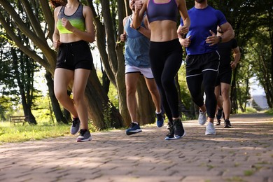 Group of people running in park, closeup