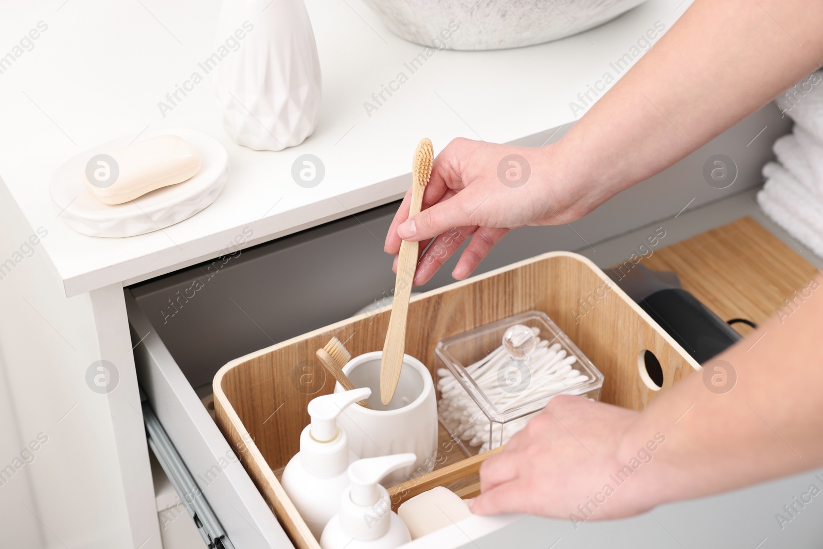 Photo of Bath accessories. Woman organizing personal care products indoors, closeup