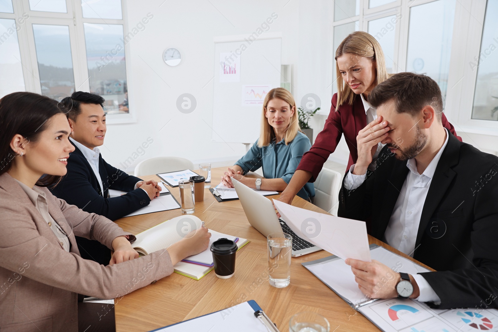 Photo of Businesswoman having meeting with her employees in office