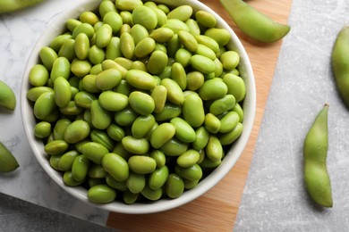 Organic edamame beans on light grey table, flat lay