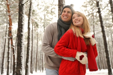 Photo of Beautiful happy couple in snowy forest on winter day