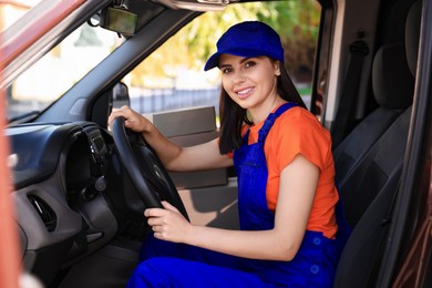 Photo of Courier wearing uniform in car. Delivery service