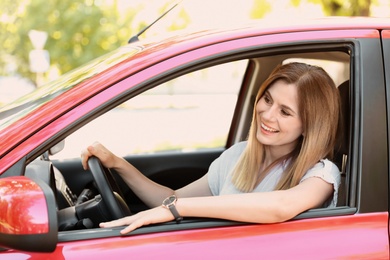 Happy beautiful woman driving modern car