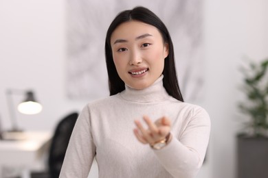 Portrait of smiling confident businesswoman in office