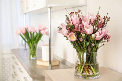 Beautiful bouquet with spring pink tulips on table indoors. Space for text