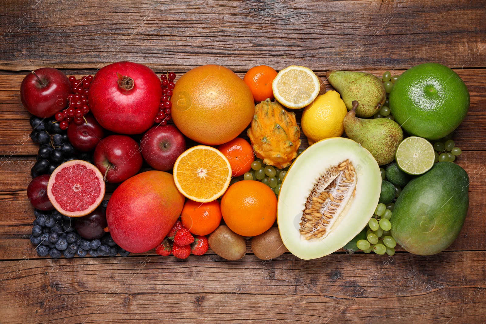 Photo of Many different fresh fruits and berries on wooden table, flat lay