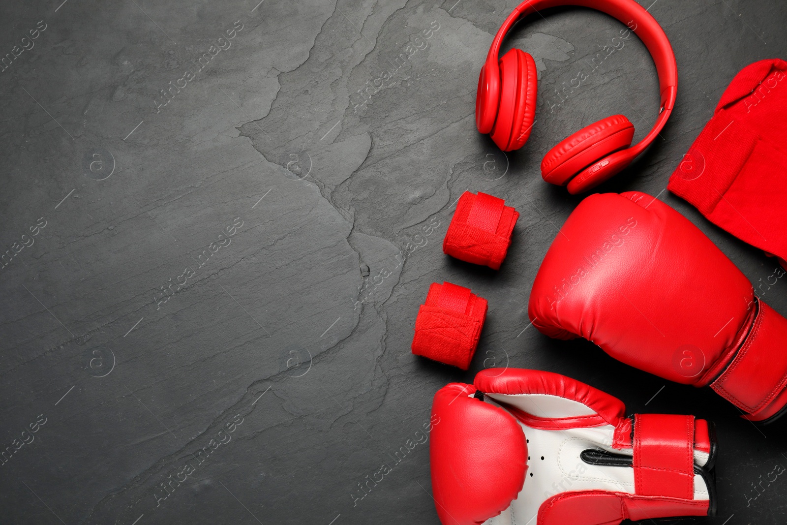 Photo of Different sports equipment on black table, flat lay. Space for text