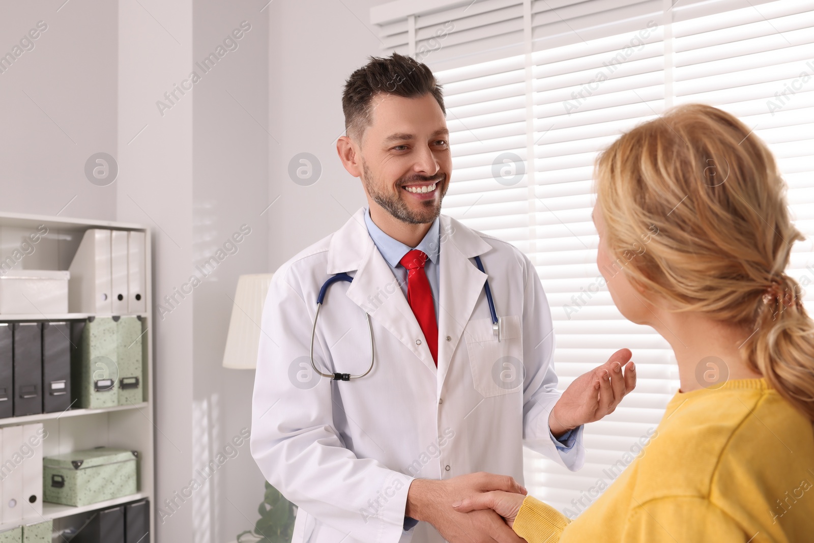 Photo of Doctor shaking hands with patient in clinic