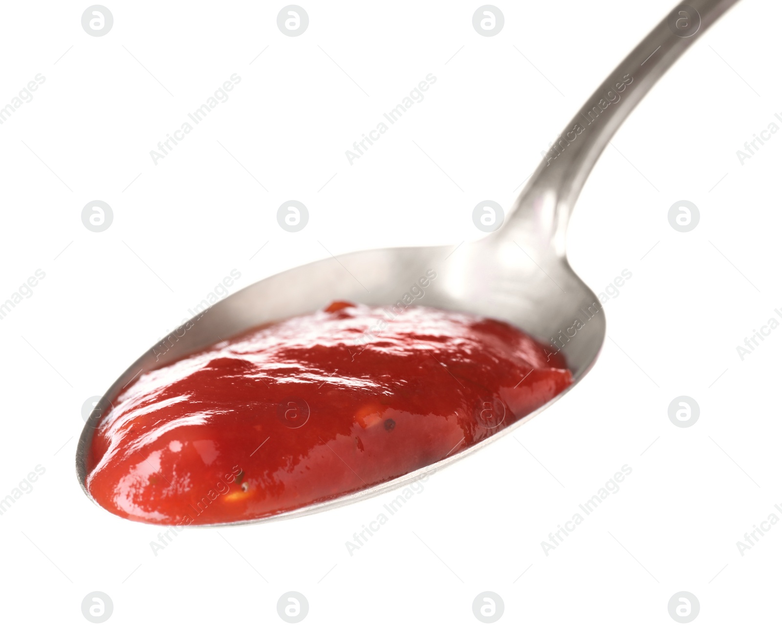 Photo of Metal spoon with red sauce on white background