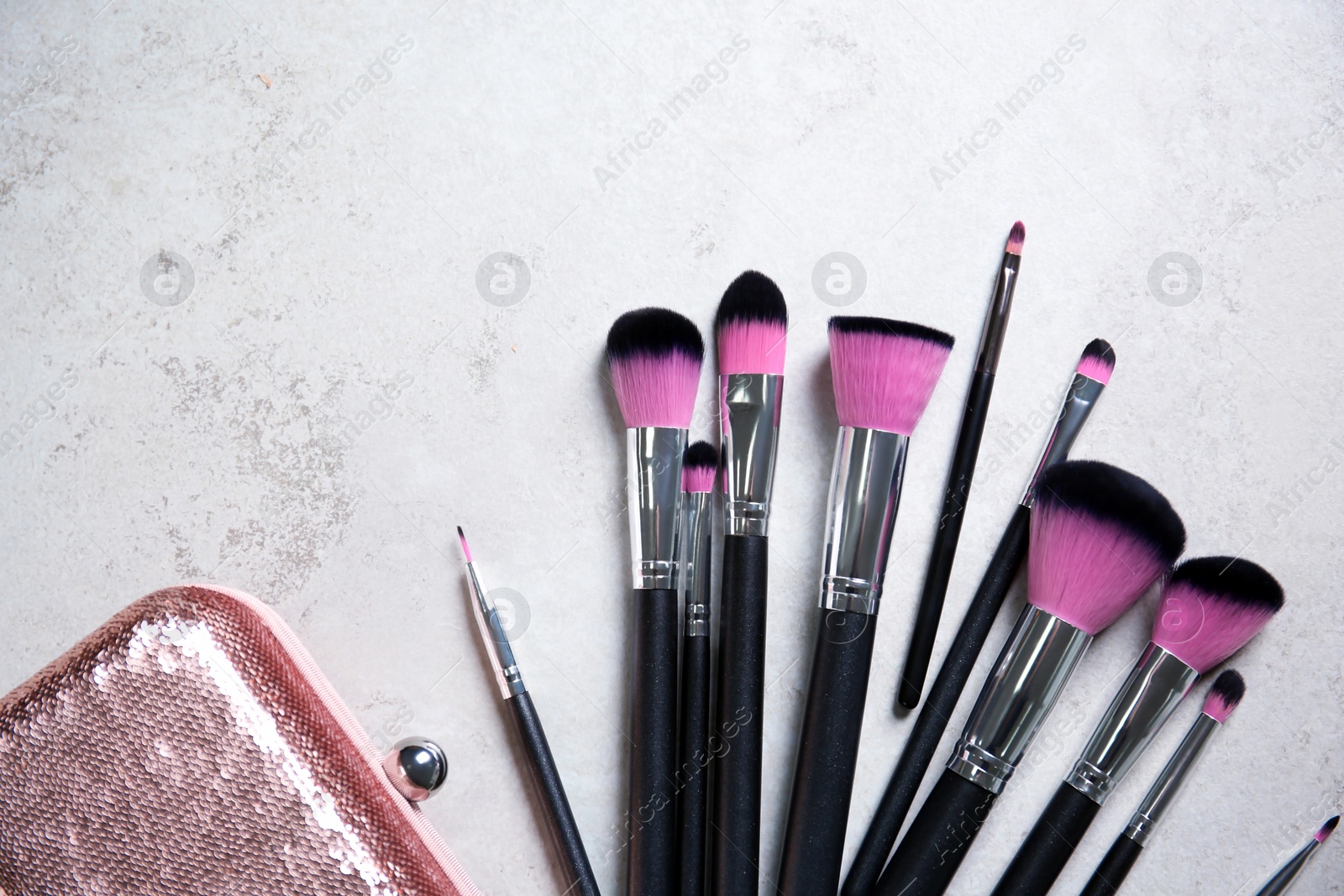 Photo of Flat lay composition with professional makeup brushes on light background