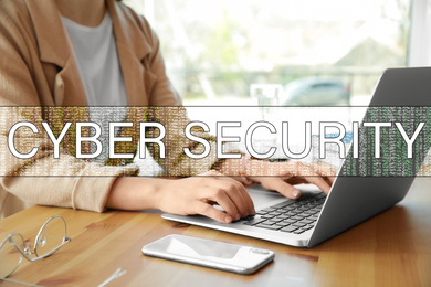Image of Cyber security concept. Woman working with laptop at table indoors, closeup