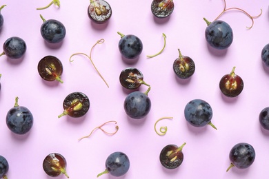 Photo of Flat lay composition with fresh ripe juicy grapes on lilac background