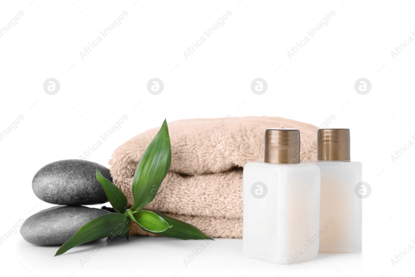 Photo of Composition with spa stones and towel isolated on white