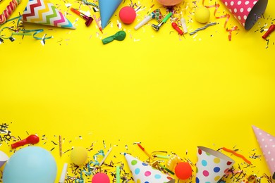 Photo of Beautiful flat lay composition with festive items on yellow background, space for text. Surprise party concept