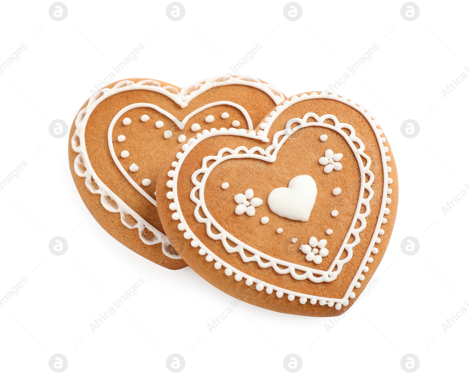 Photo of Gingerbread hearts decorated with icing on white background, above view