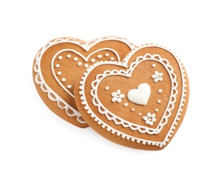 Photo of Gingerbread hearts decorated with icing on white background, above view