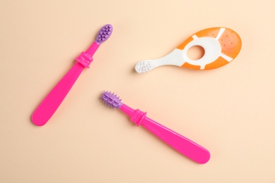 Manual toothbrushes for children on color background, top view