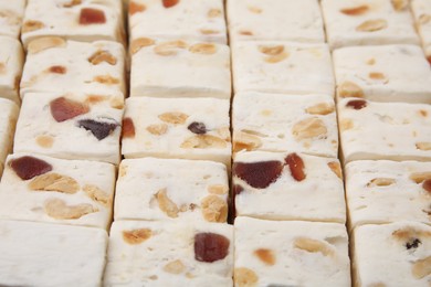 Photo of Pieces of delicious nougat as background, closeup