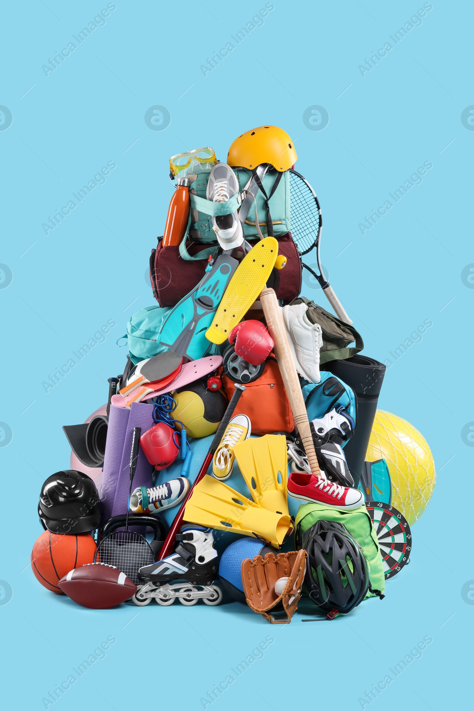 Photo of Many different sports equipment on light blue background