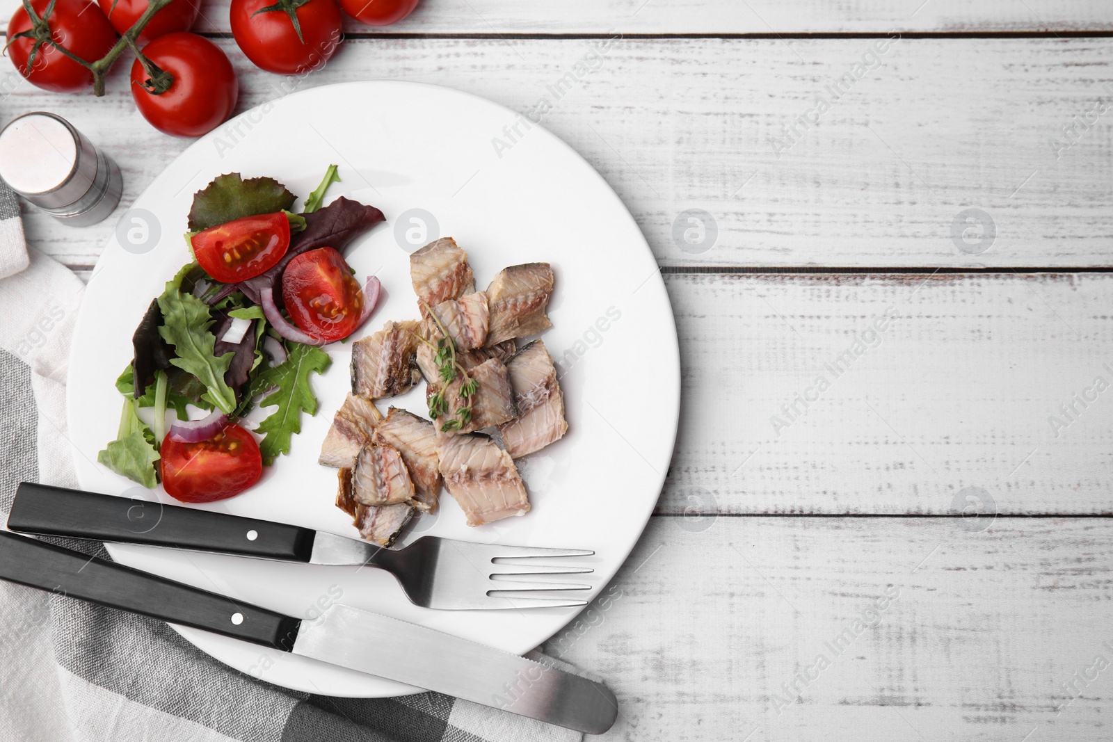 Photo of Delicious canned mackerel chunks served on white wooden table, flat lay. Space for text