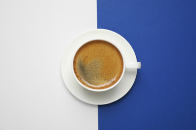 Photo of Black coffee on blue and white background, top view. Color of the year 2020 (Classic blue)