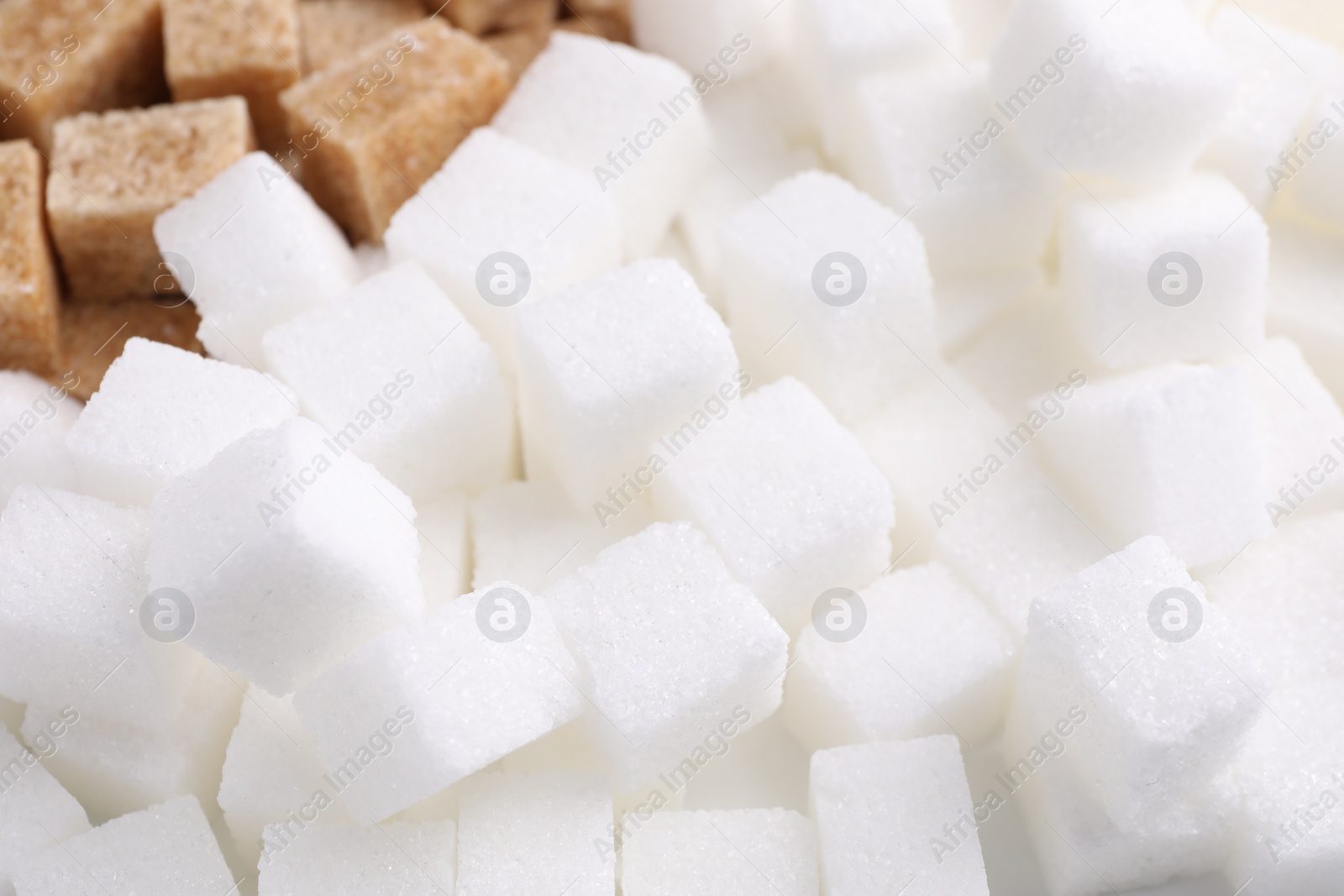 Photo of White and brown sugar cubes as background, closeup