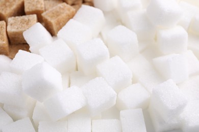 Photo of White and brown sugar cubes as background, closeup