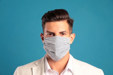 Photo of Man in protective face mask on blue background