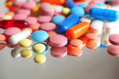 Photo of Colorful pills on reflective surface