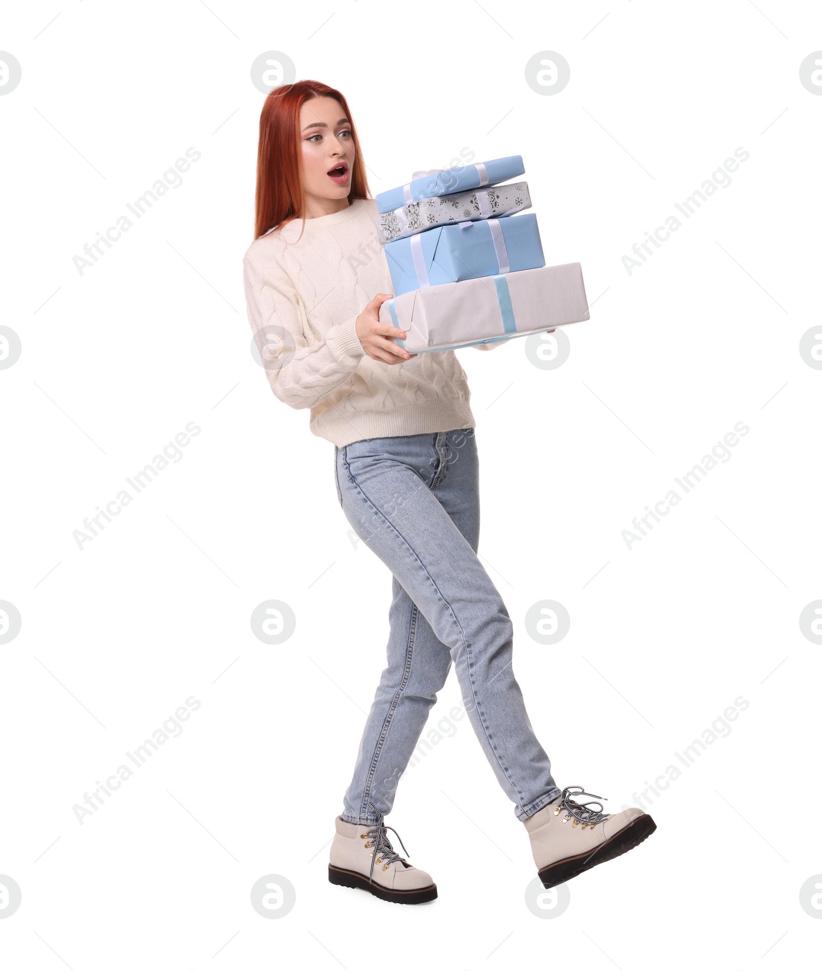 Photo of Young woman in sweater with Christmas gifts on white background