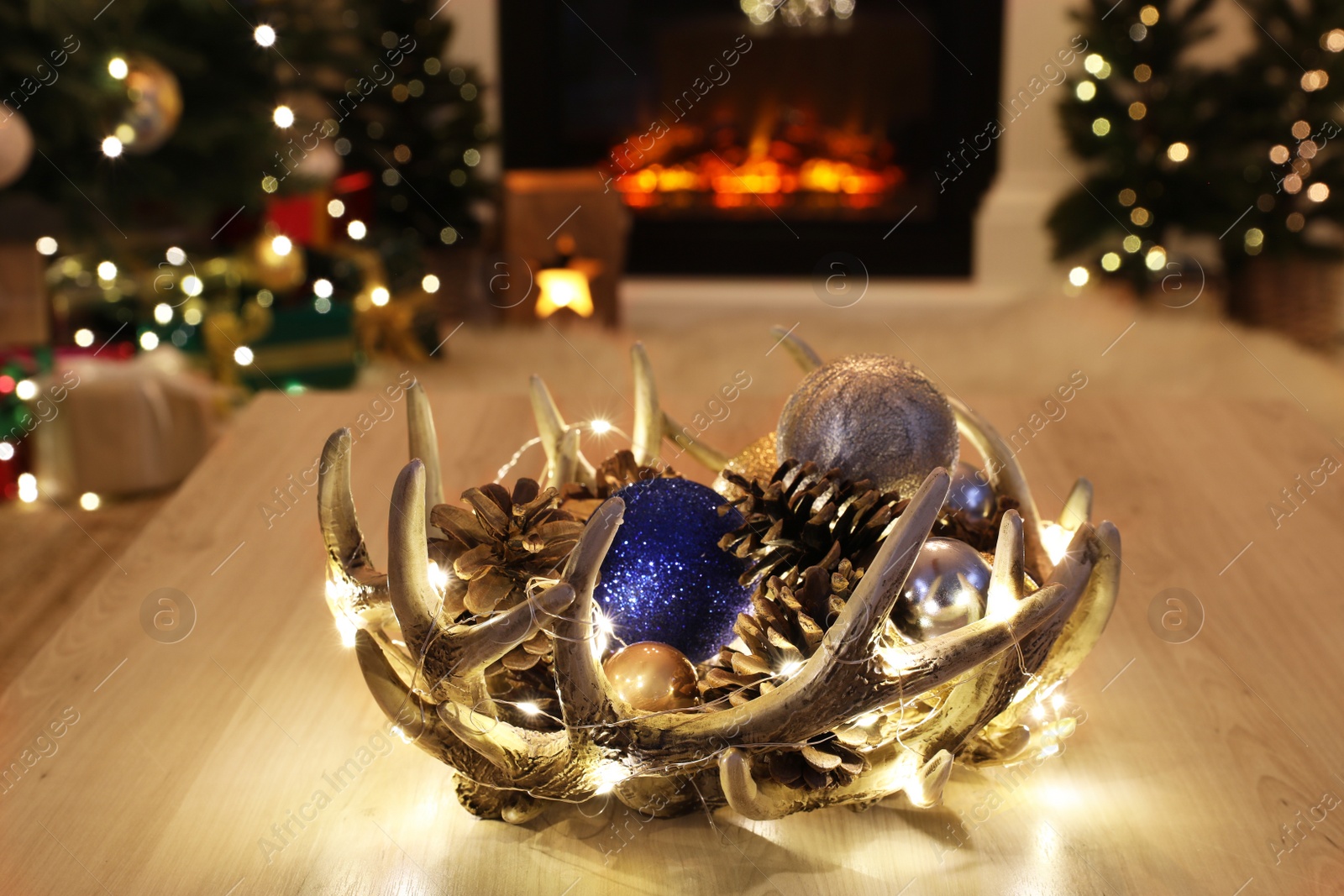 Photo of Beautiful Christmas decor on wooden table in room. Interior design