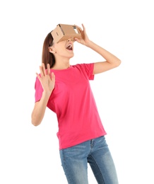 Photo of Young woman using cardboard virtual reality headset, isolated on white