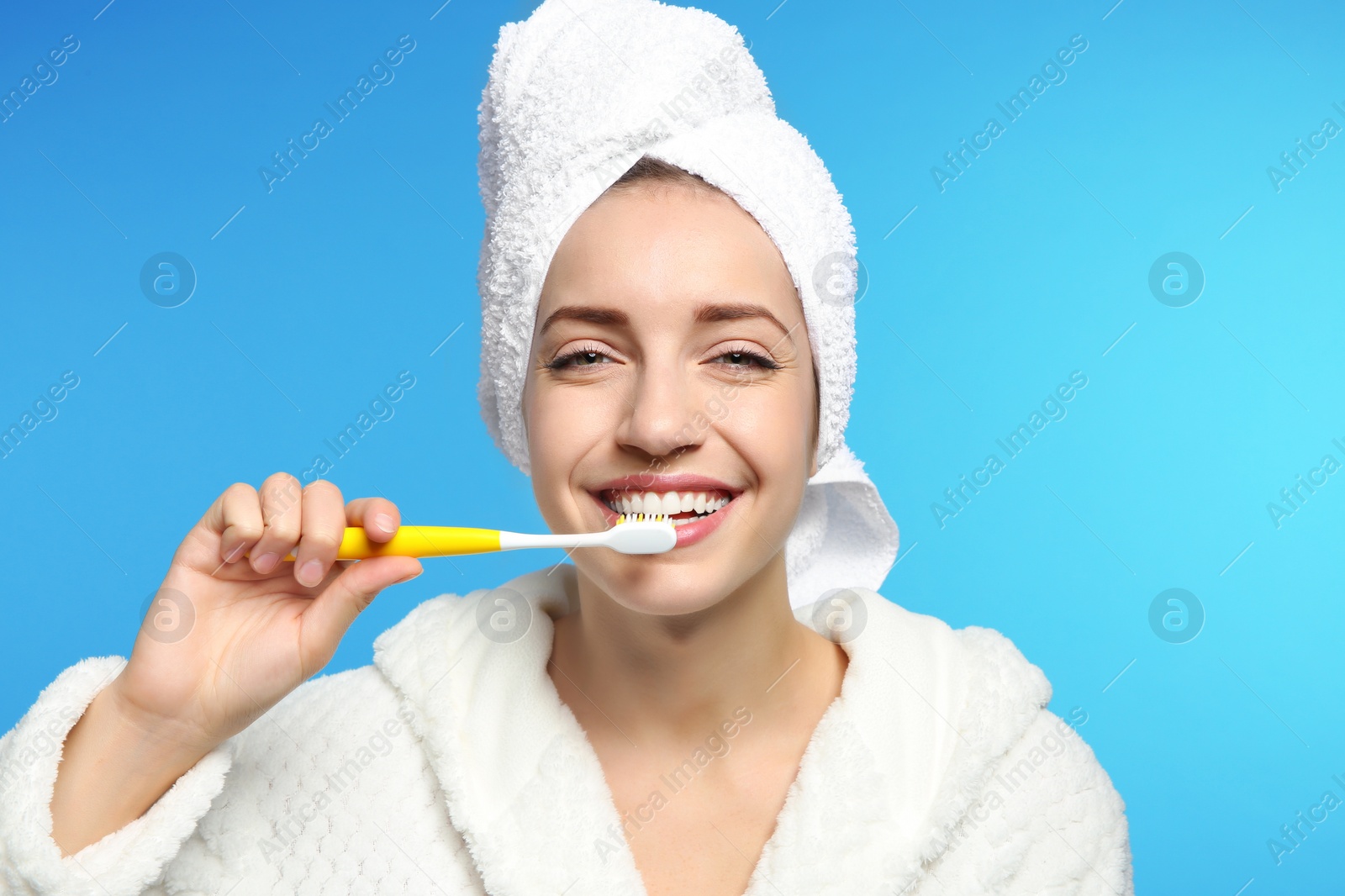 Photo of Portrait of young woman with toothbrush on color background