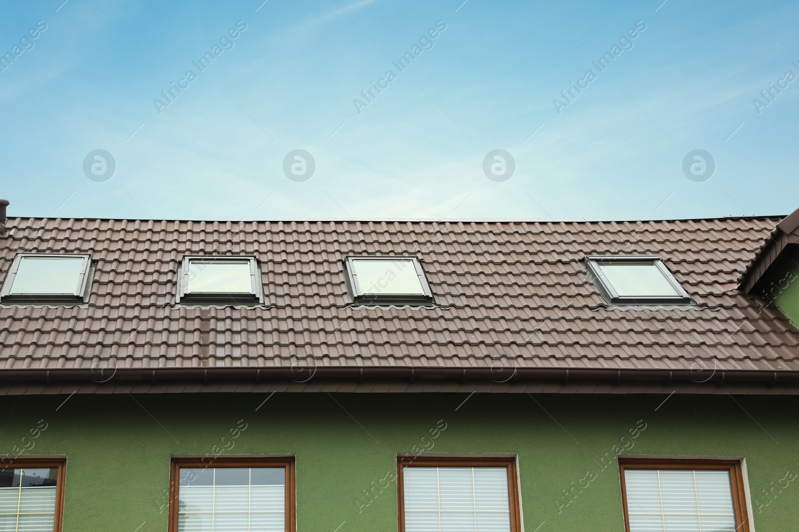 Photo of Beautiful house with color roof against blue sky, low angle view