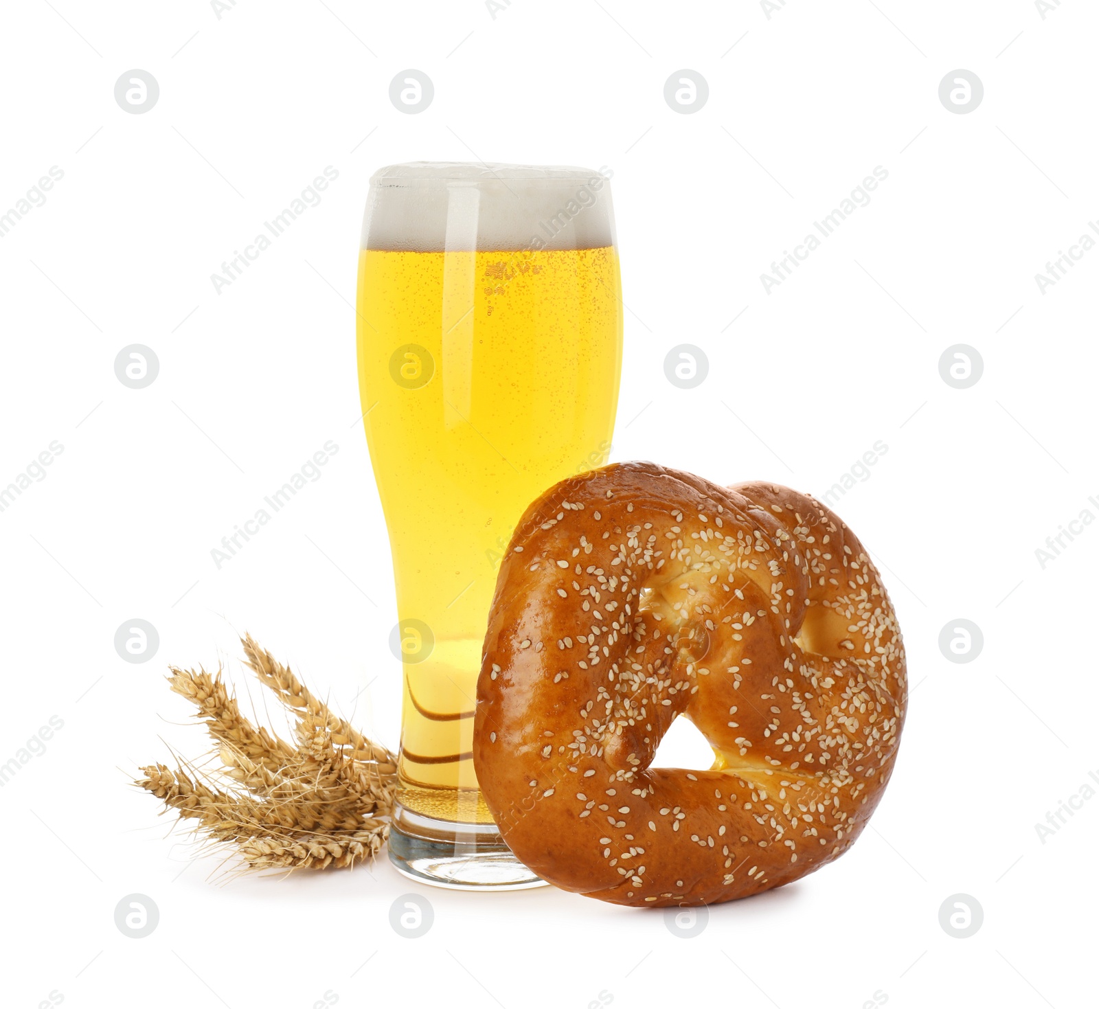 Photo of Tasty freshly baked pretzel, glass of beer and spikelets on white background
