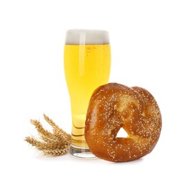 Photo of Tasty freshly baked pretzel, glass of beer and spikelets on white background