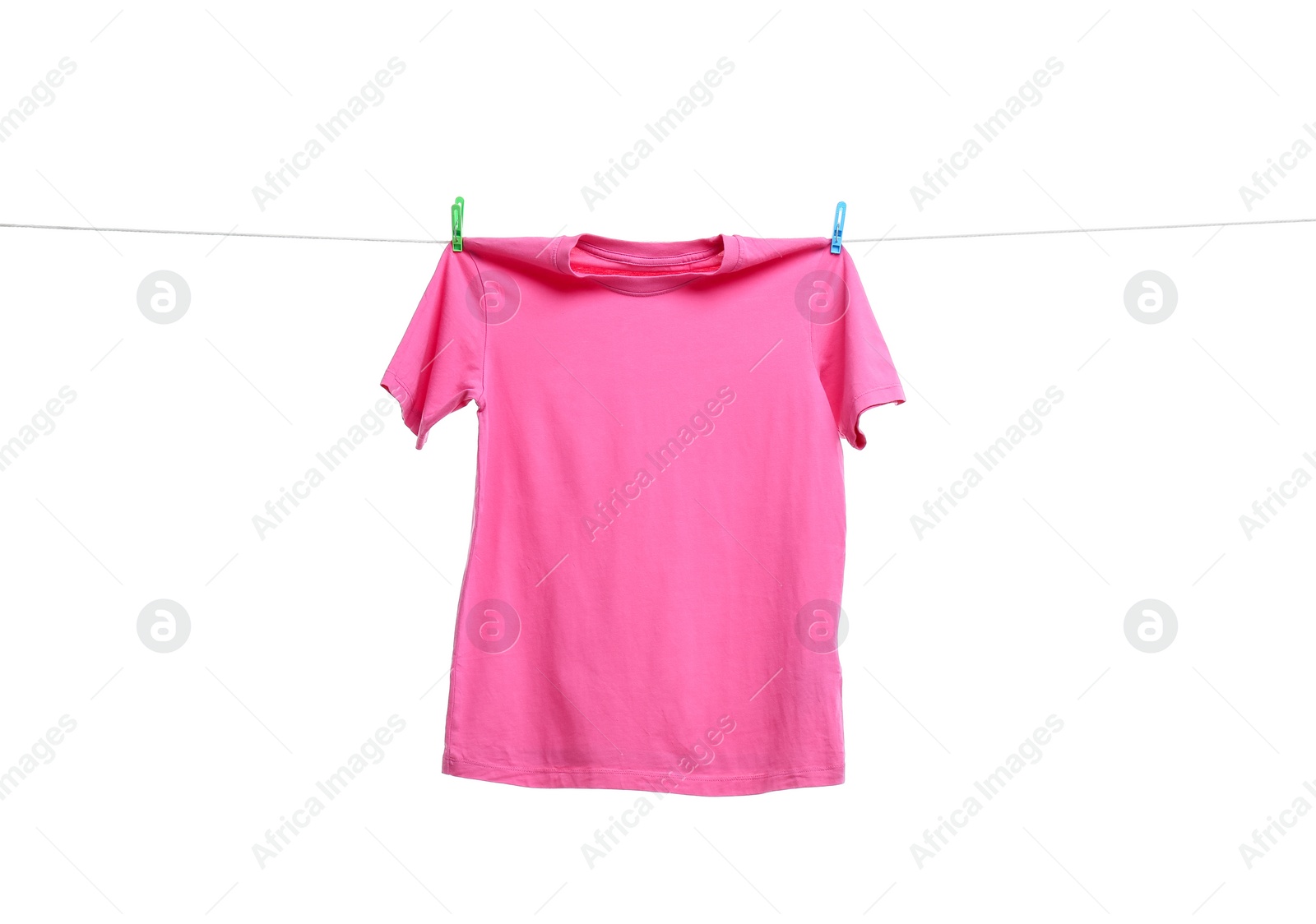 Photo of Pink t-shirt drying on washing line against white background