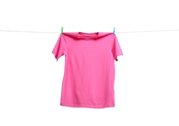 Photo of Pink t-shirt drying on washing line against white background