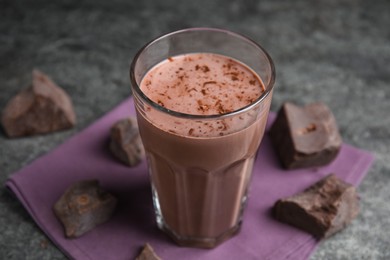 Photo of Delicious chocolate milk in glass on grey table