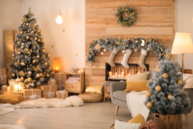 Little Christmas tree in festive living room interior