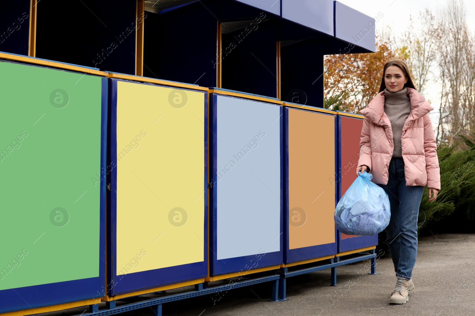 Photo of Woman throwing garbage at recycling point outdoors