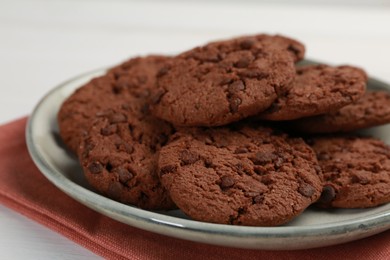 Photo of Delicious chocolate chip cookies on white table, closeup